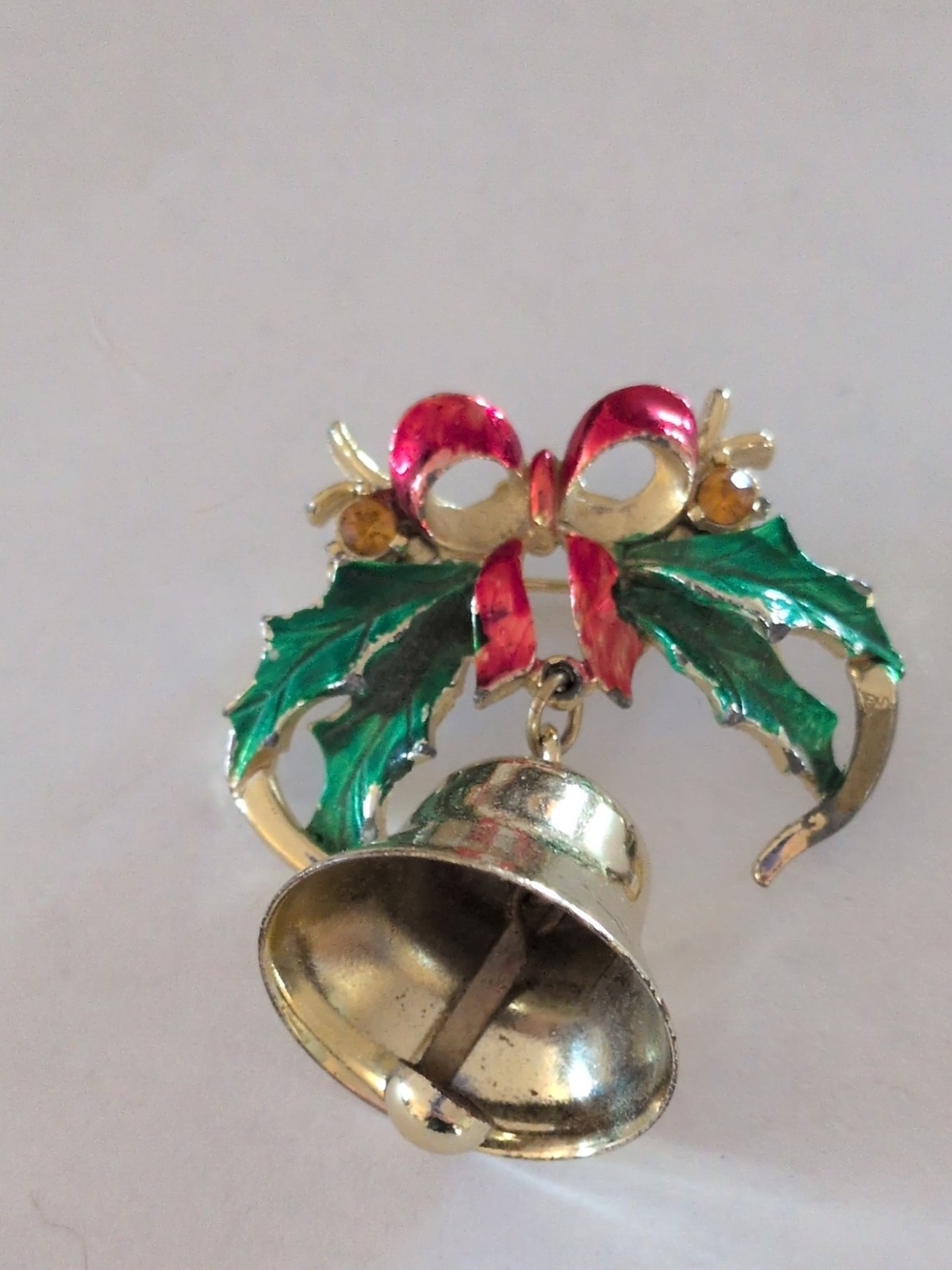Gold-tone Holiday Bell Brooch with Green Leaves and Red Bow